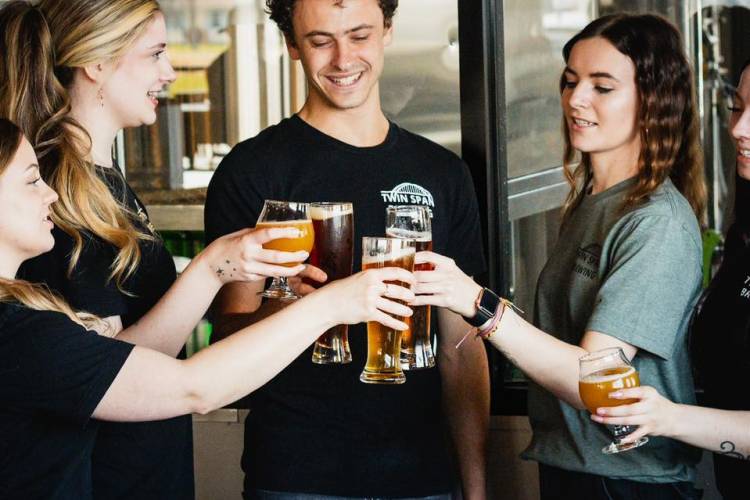 Image of woman pouring beer from a keg