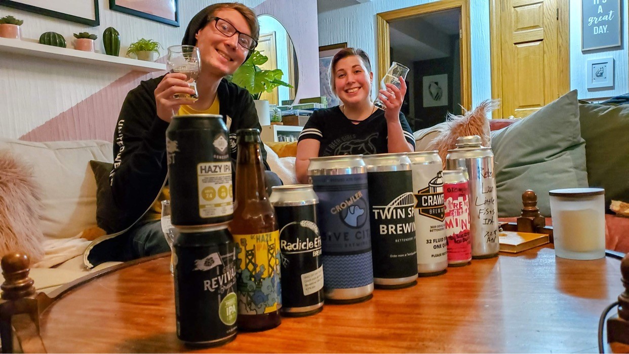 young man and women tasting light beer samples